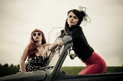 8080183-two-attractive-retro-50s-style-dressed-girls-posing-on-car.webp