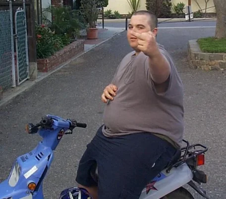 Fat-guy-on-moped.webp