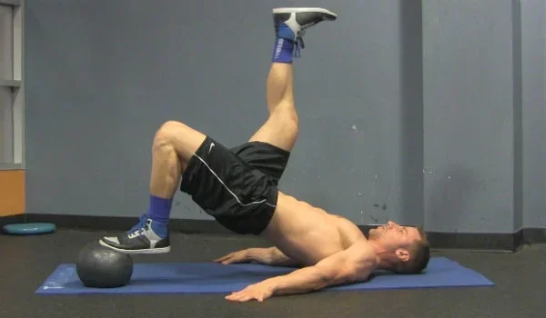 medicine_ball_hamstring_curls_workout_video_pic.webp